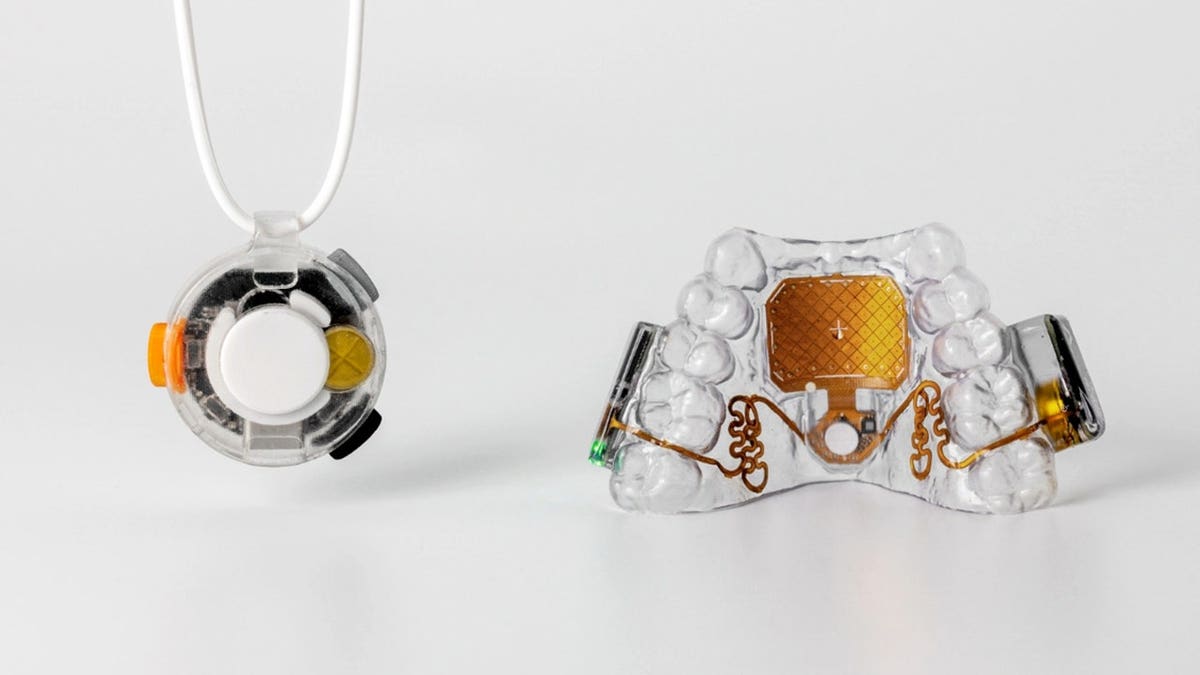 The MouthPad is pictured next to the Vox wearable microphone.