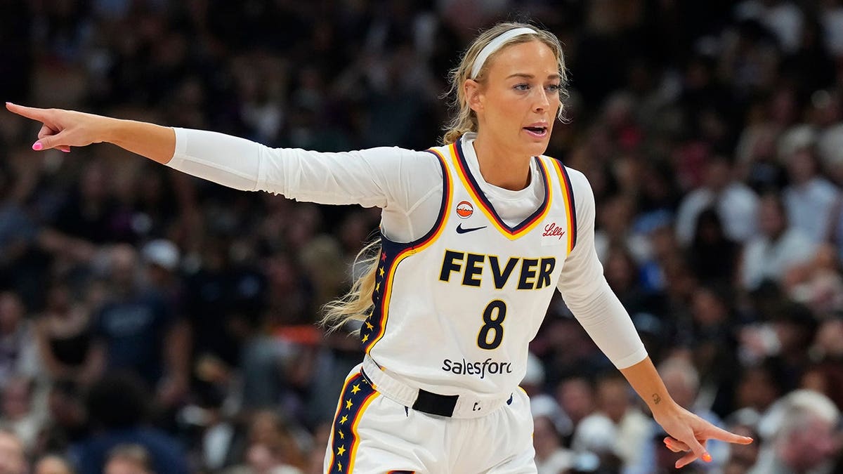 Sophie Cunningham points during a WNBA game