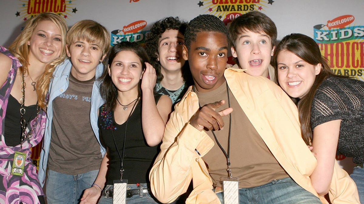 Cast of Ned's Declassified School Survival Guide stands on orange carpet at Kids' Choice Awards.