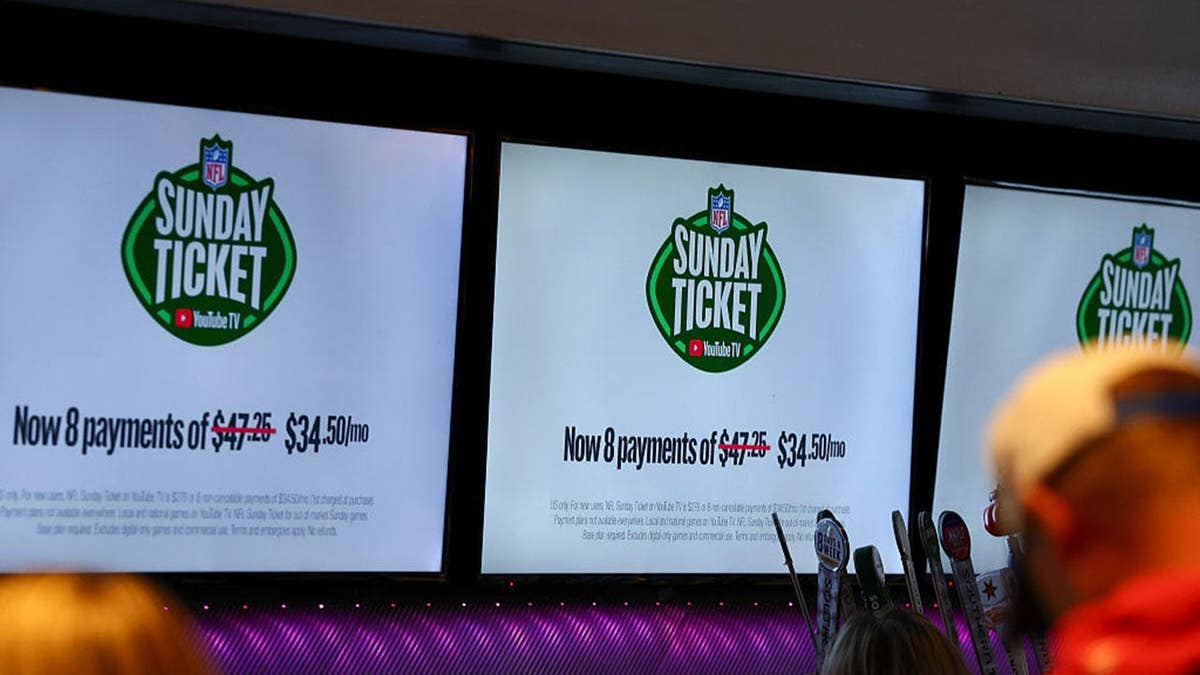NFL Sunday Ticket ad displayed on bar television as patrons watch Kansas City Chiefs and Los Angeles Chargers game.