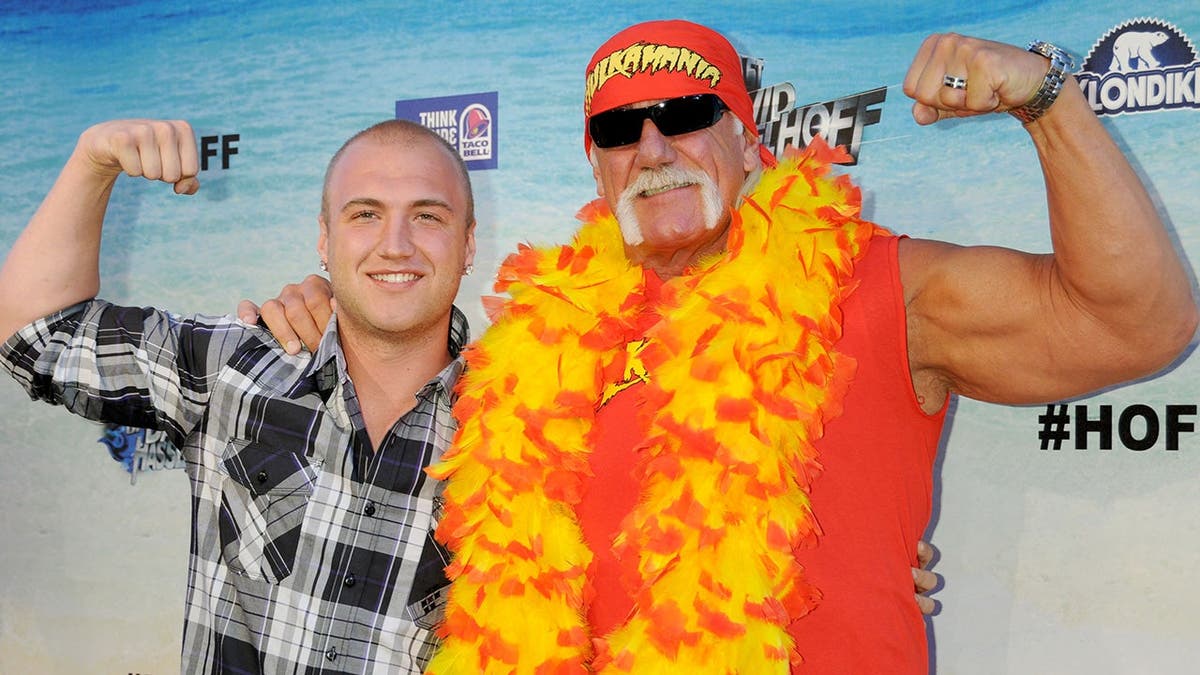 Nick Hogan and Hulk Hogan stand together at an event.