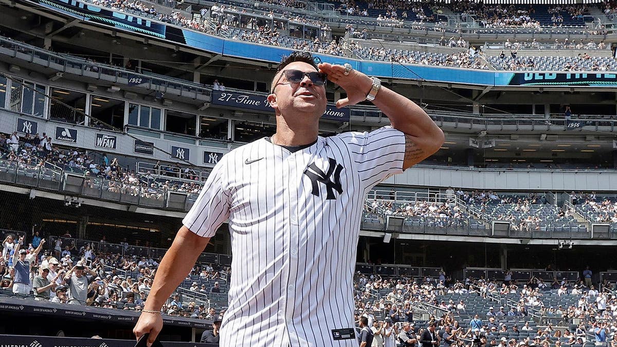 Nick Swisher stands at Yankee Stadium during Old-Timers' Day.