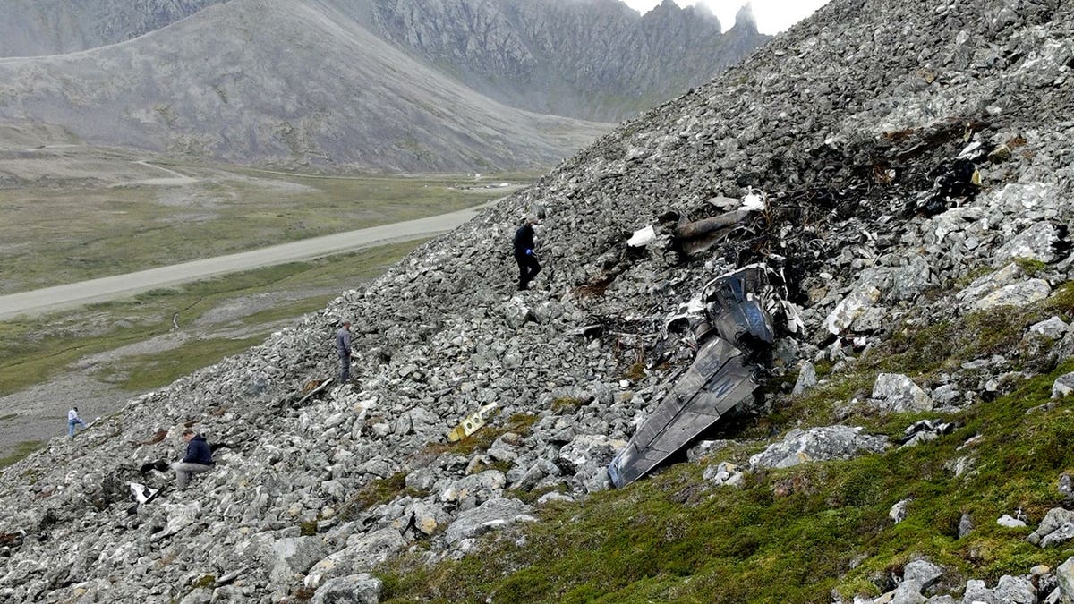 NTSB investigators document the accident site of a Cessna 441 airplane near Cape Newenham, Alaska.
