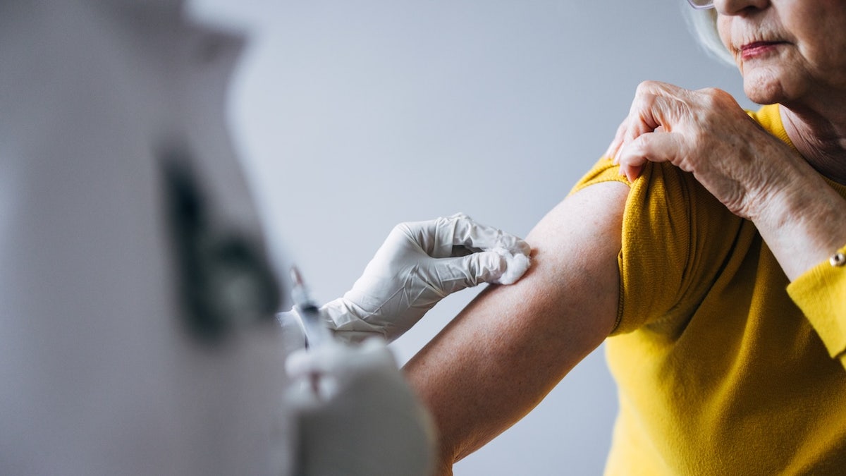 Older adult woman getting vaccine