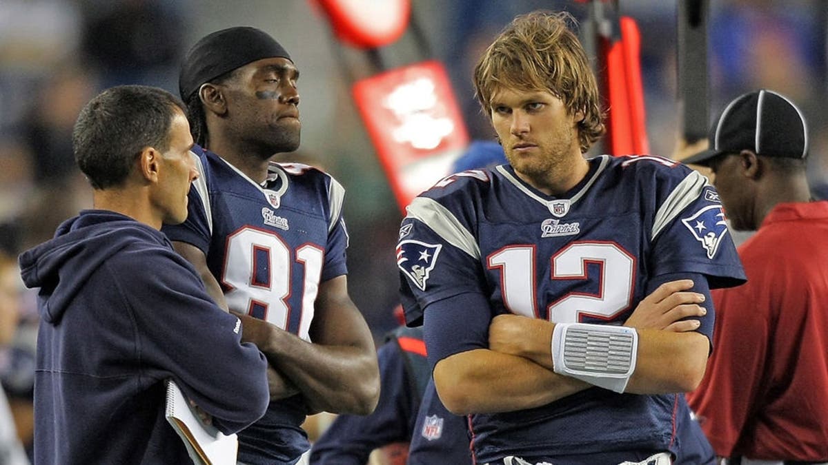 Randy Moss and Tom Brady react during a preseason game at Gillette Stadium.