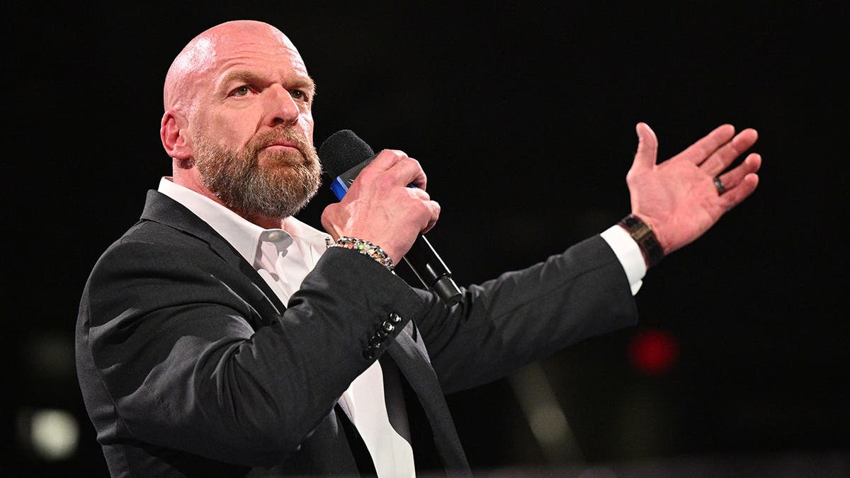 Paul Levesque, known as Triple H, addresses the crowd at Gainbridge Fieldhouse.