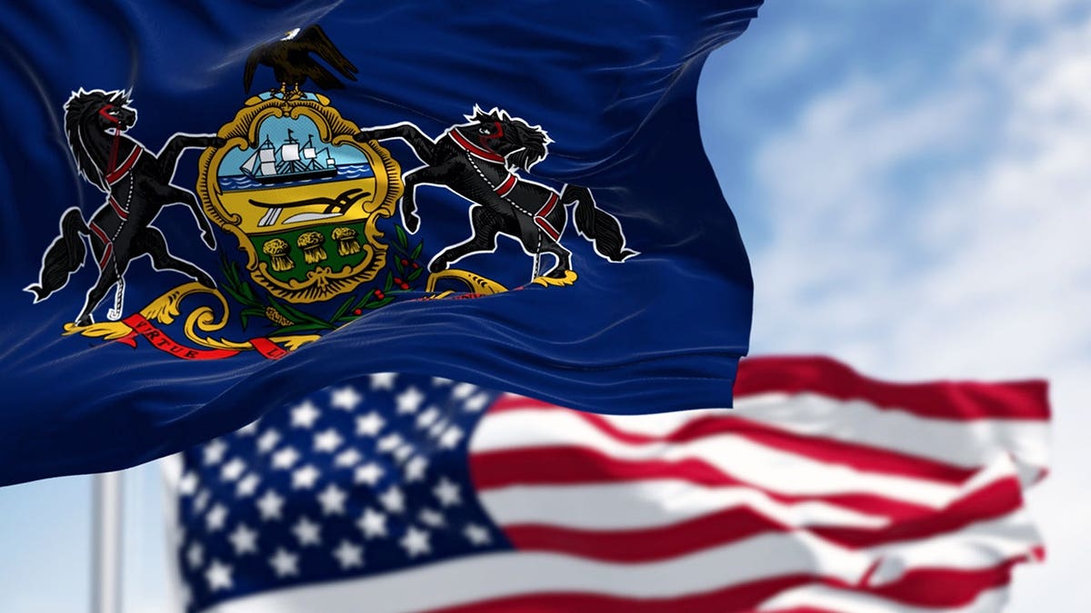 Pennsylvania state flag and American flag waving together