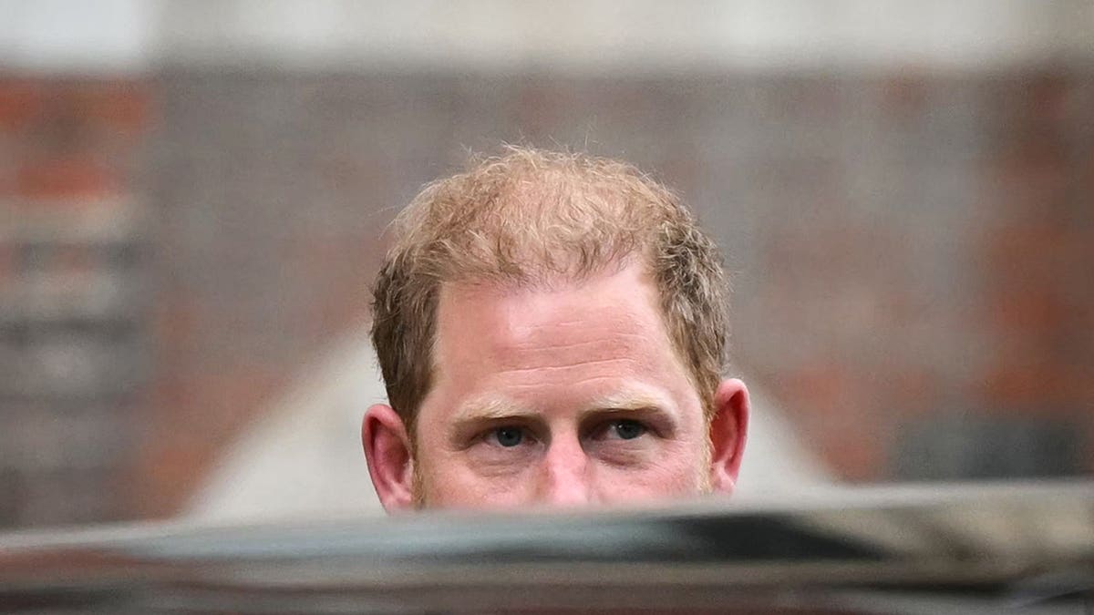 Prince Harry, Duke of Sussex, reacts while leaving the High Court in central London.