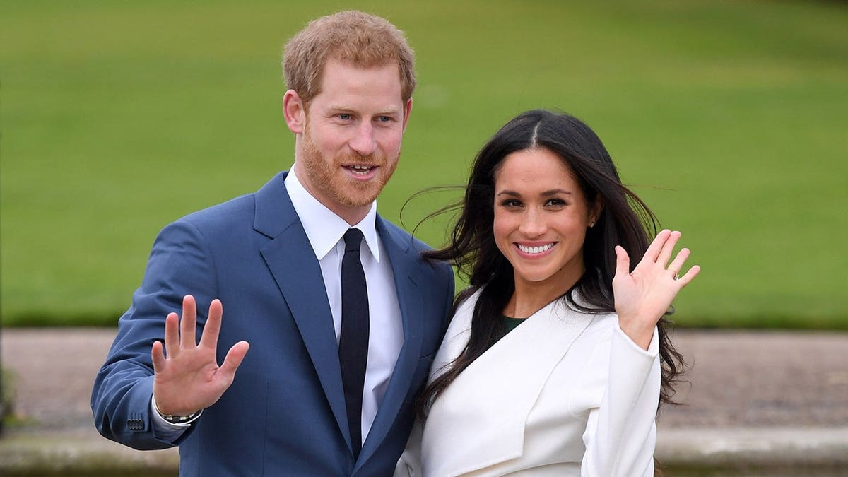 Prince Harry and Meghan Markle stand together at an official photocall at Kensington Palace.