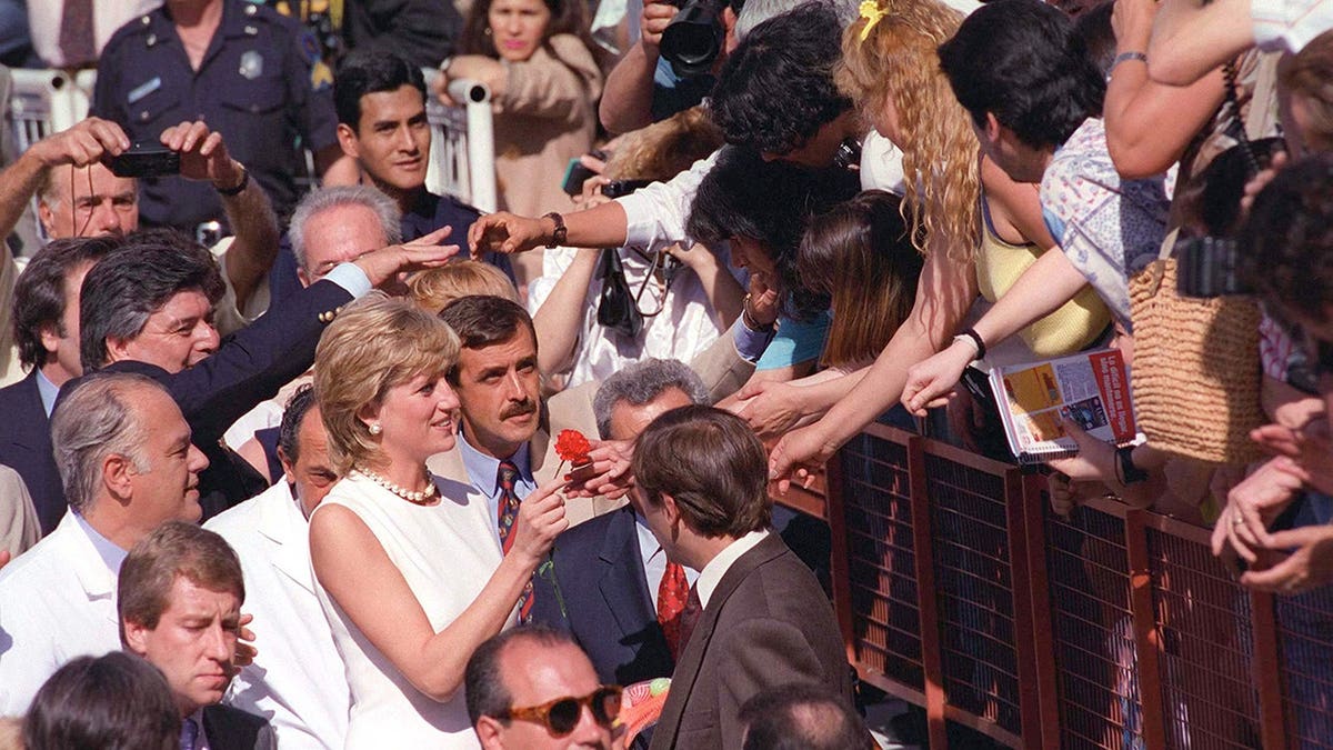 Princess Diana waves to crowds during a visit to Argentina.