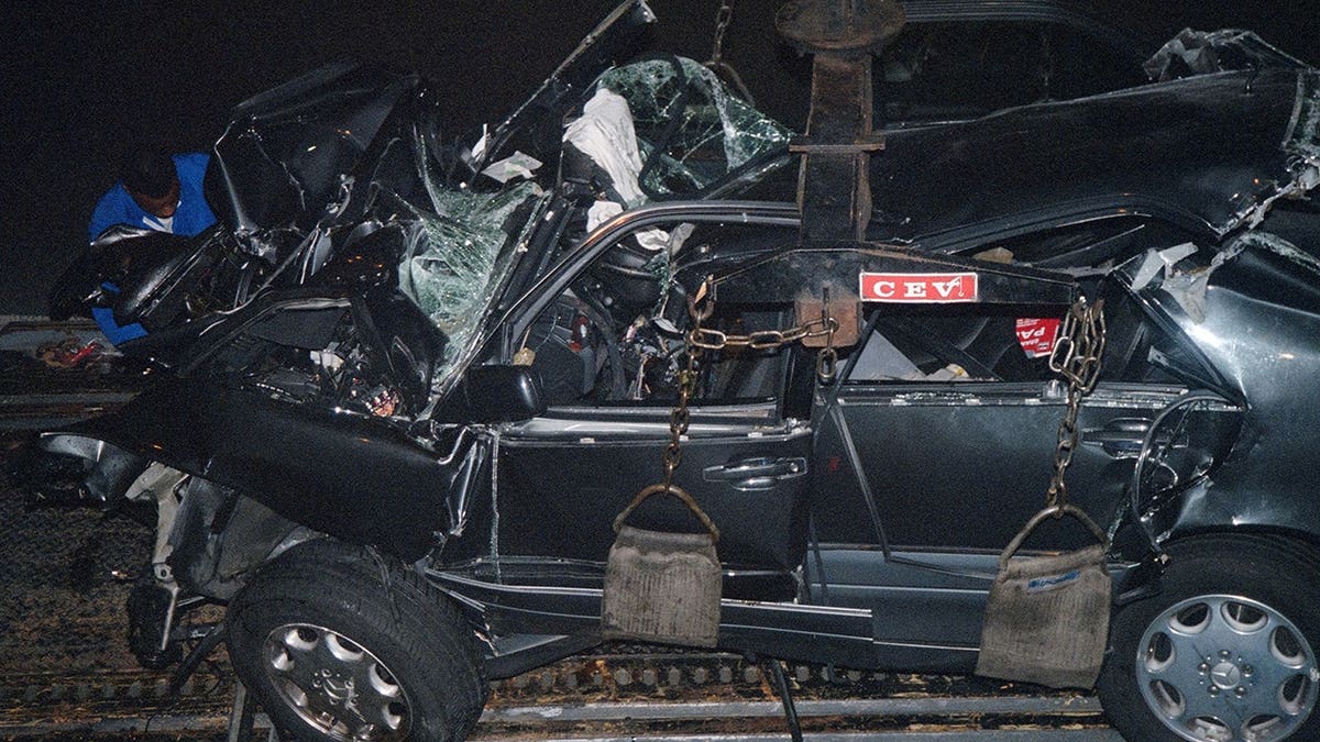 Princess Diana's car wreckage is loaded onto a truck in the Alma Tunnel in Paris.