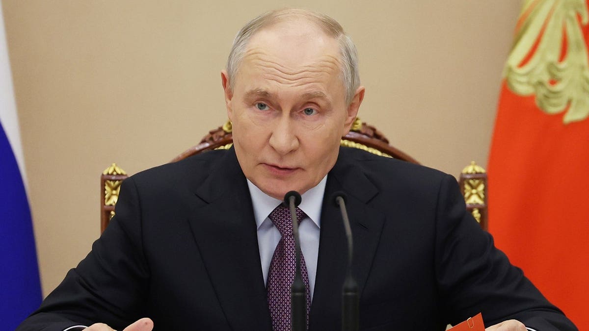 Vladimir Putin sits at a desk during a Security Council meeting in Moscow.