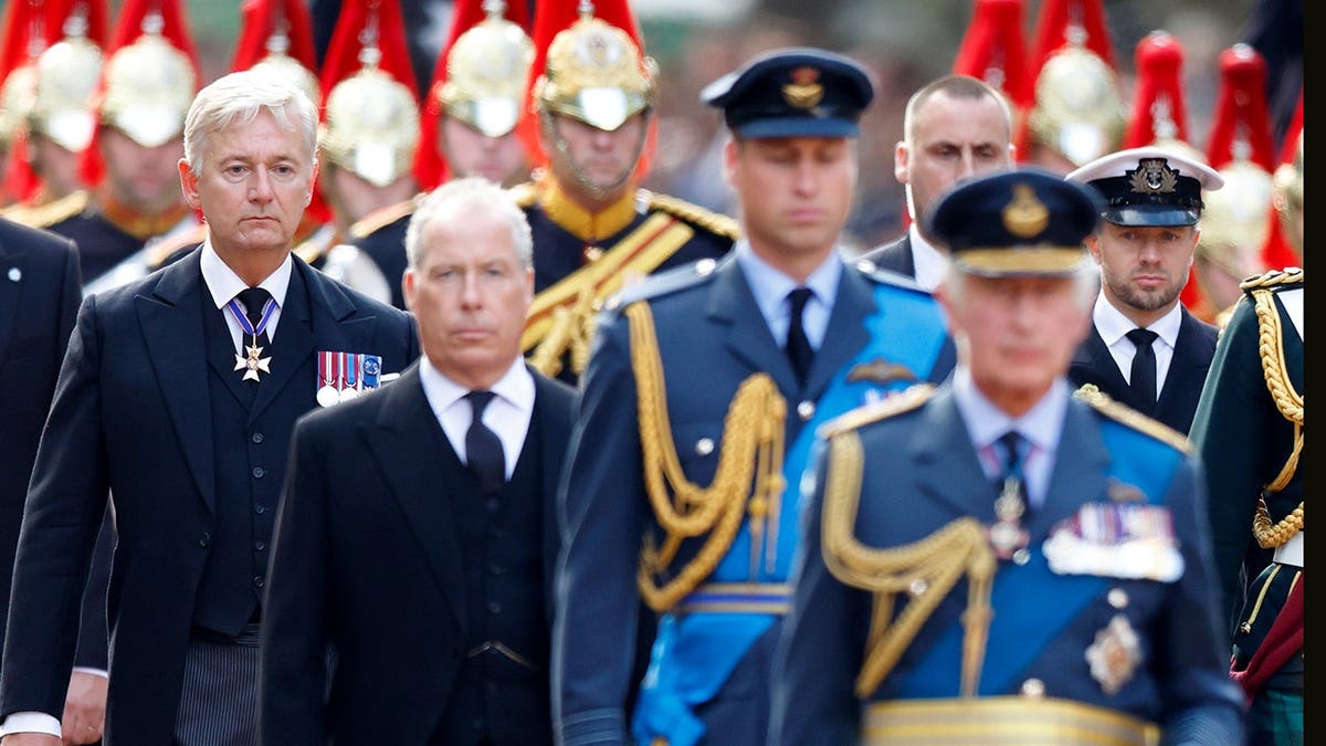 King Charles III, Prince William, David Armstrong-Jones and Sir Clive Alderton walk behind Queen Elizabeth II's coffin.