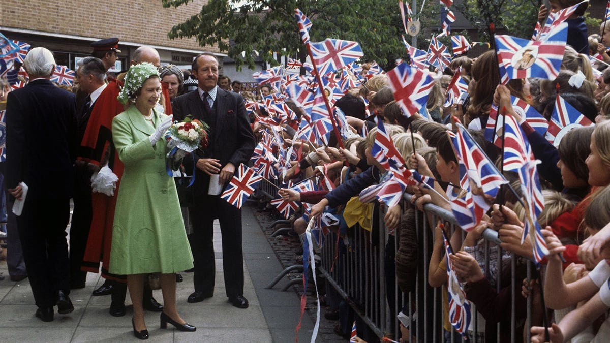 Queen Elizabeth II walks among crowds in Solihull.