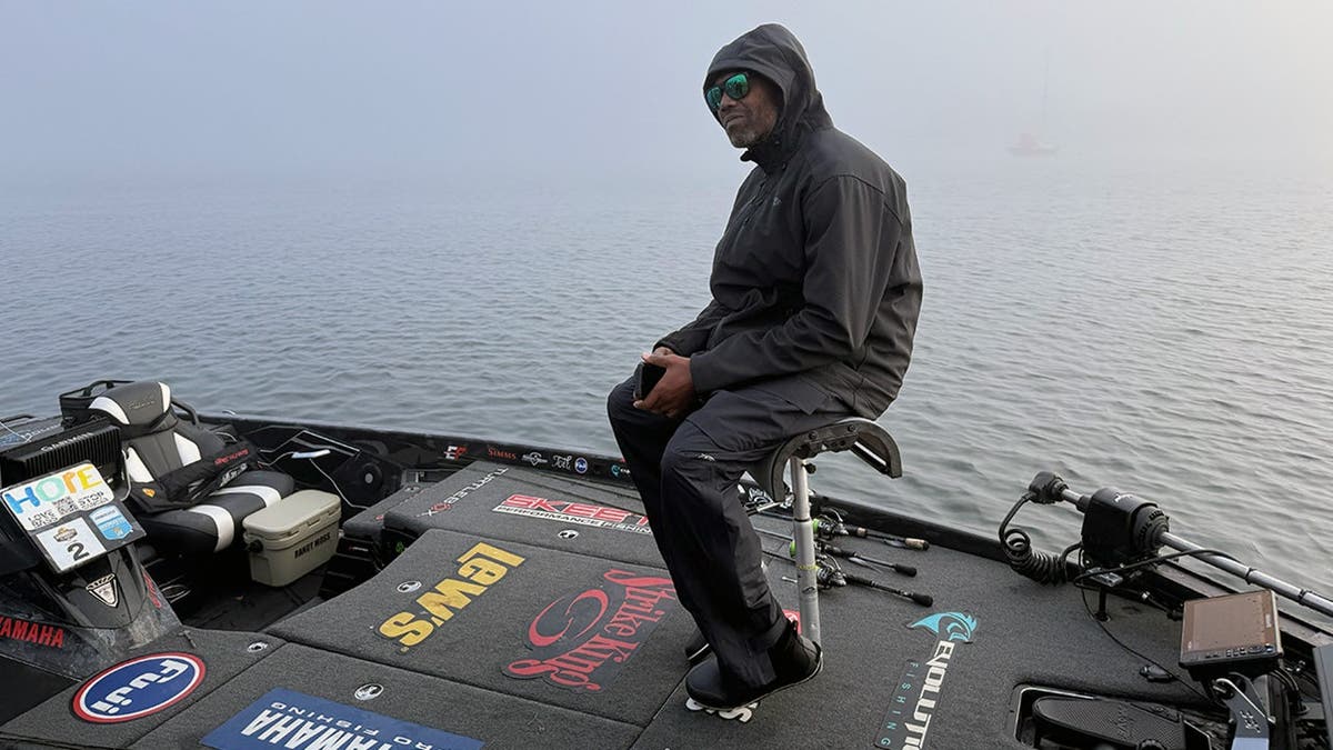 Randy Moss sits on his boat on a foggy morning