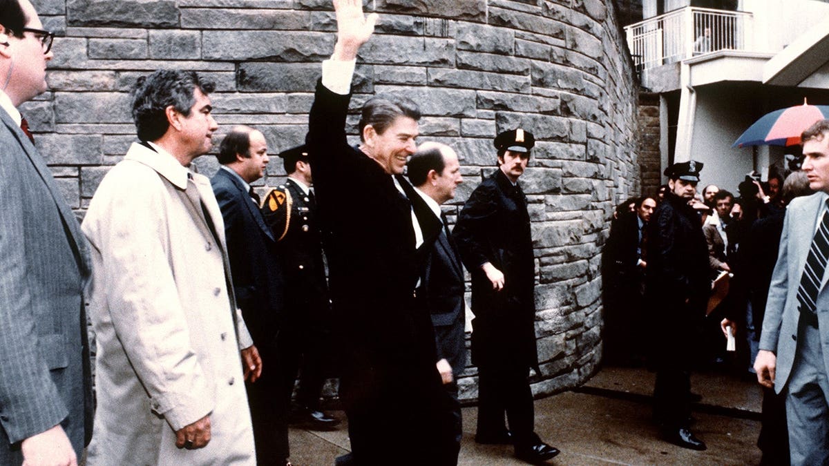 President Ronald Reagan waves to crowd outside the Hilton Hotel in Washington, D.C., before assassination attempt.