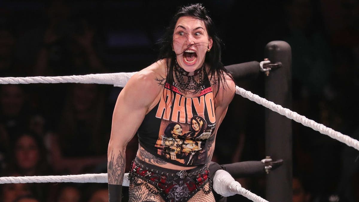 Rhea Ripley prepares to deliver a move during a WWE wrestling match.