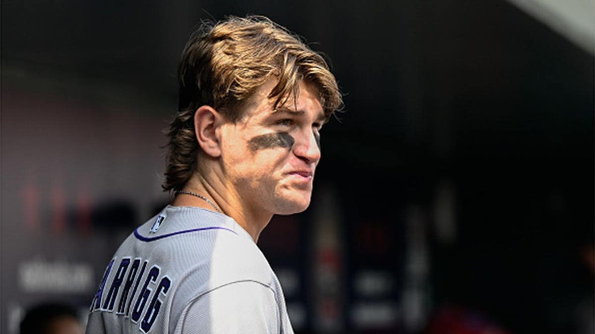 Cole Carrigg stands in the dugout during a game at Nationals Park.