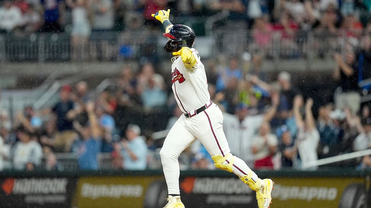 Ronald Acuña Jr. celebrates after hitting a home run.