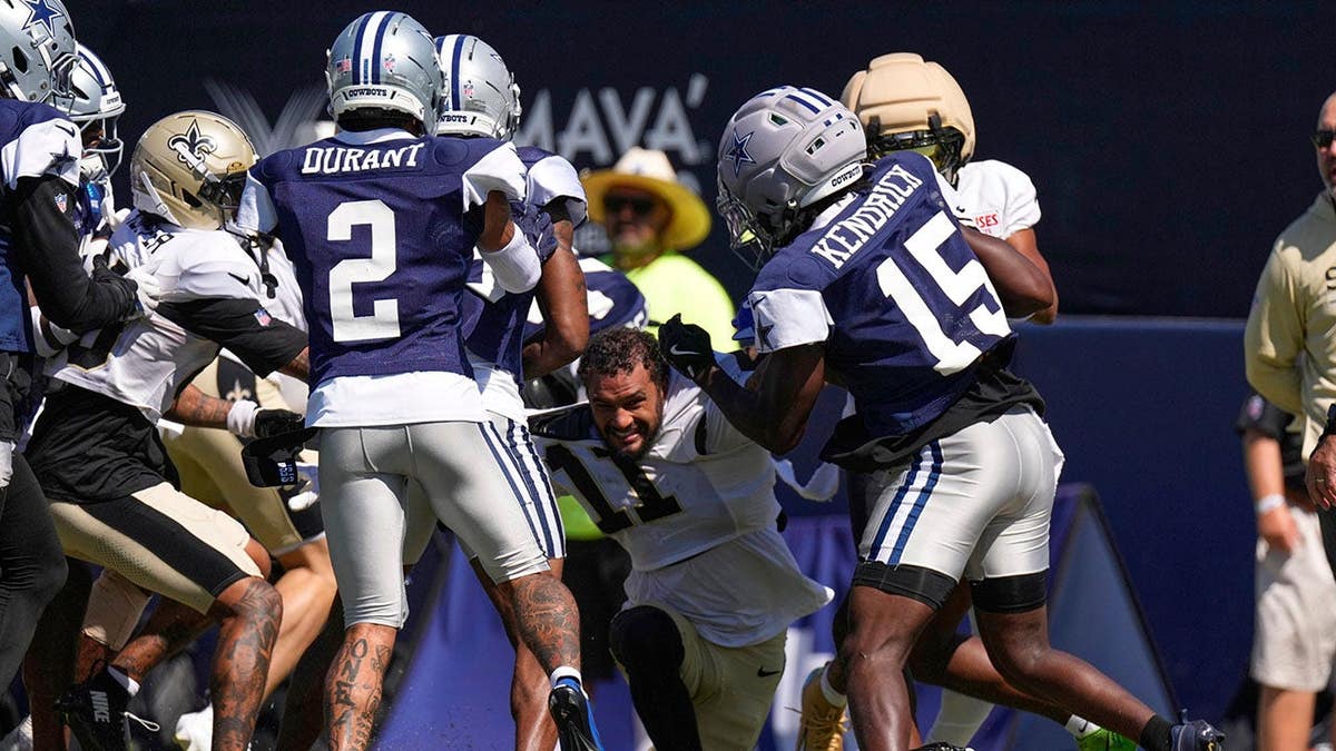Ronnie Bell fights with Dallas Cowboys players during a joint practice.