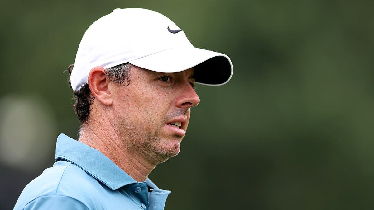 Rory McIlroy reacts on the third hole during the first round of the Tour Championship golf tournament in Atlanta.