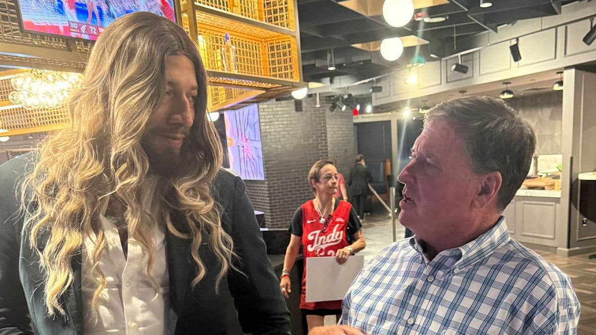 Former NBA player Royce White, who declared for the 2027 WNBA Draft, and Indiana Attorney General Todd Rokita talk in Indianapolis during halftime of an Indiana Fever-Connecticut Sun game about the importance of protecting biological girls and women in girls and women's sports.