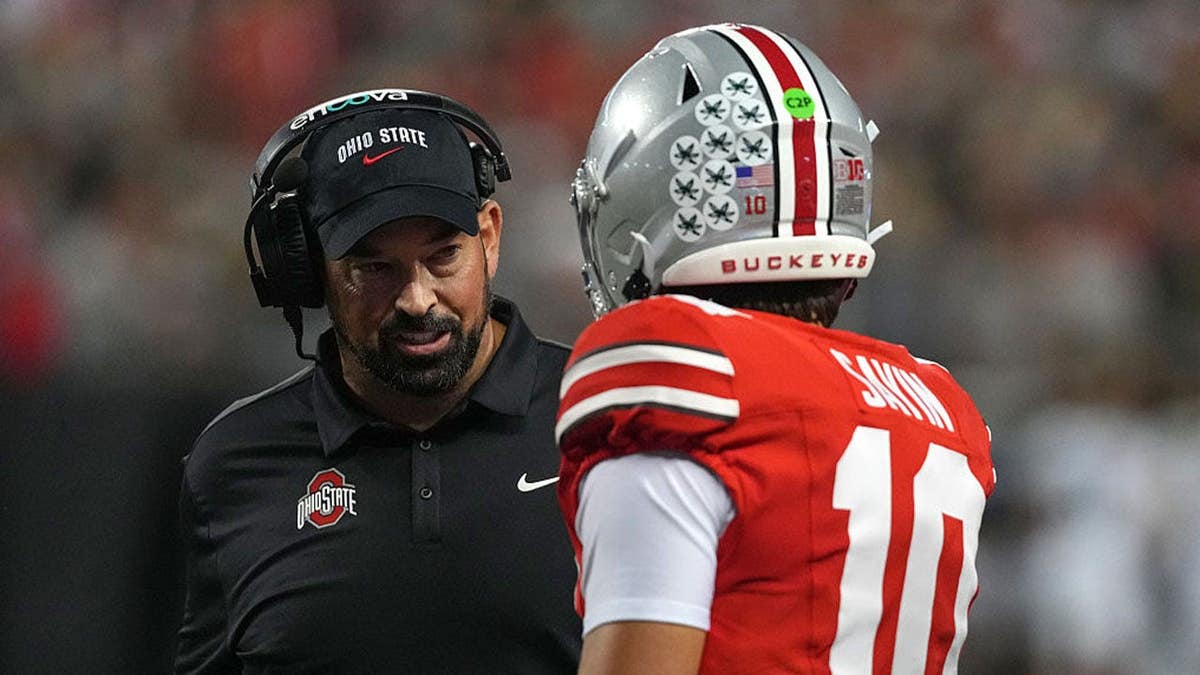 Head Coach Ryan Day of the Ohio State Buckeyes talks with Quarterback Julian Sayin