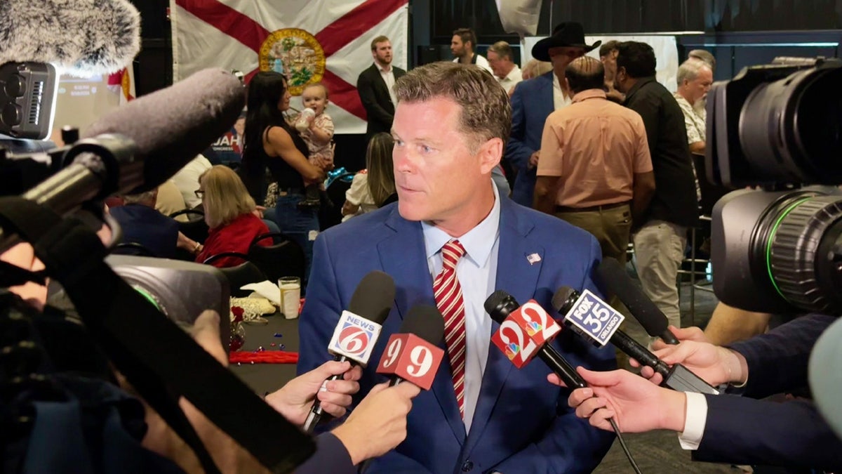 An image of candidate Ryan Elijah surrounded by reporters