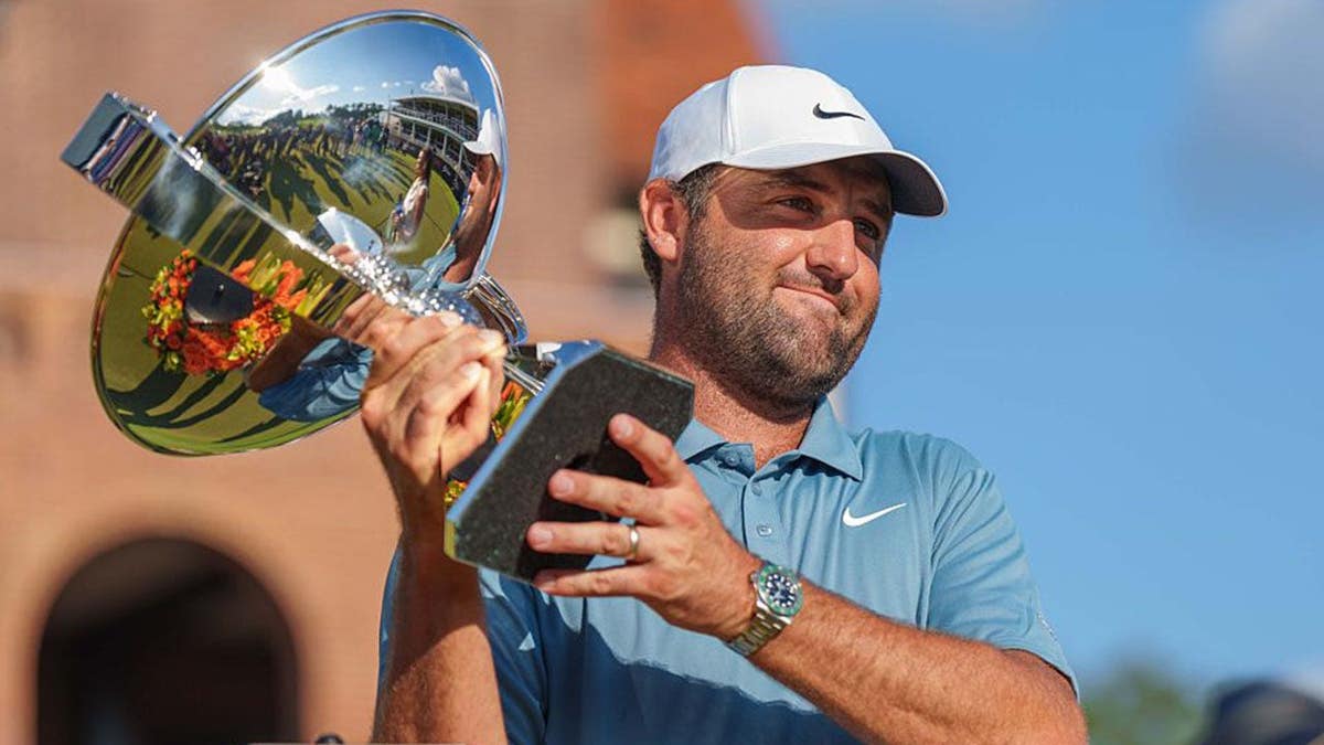 Scottie Scheffler of the USA holds the FedEx Cup Trophy