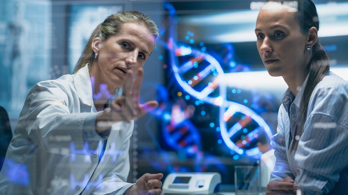 Physician and patient examine a holographic DNA model.