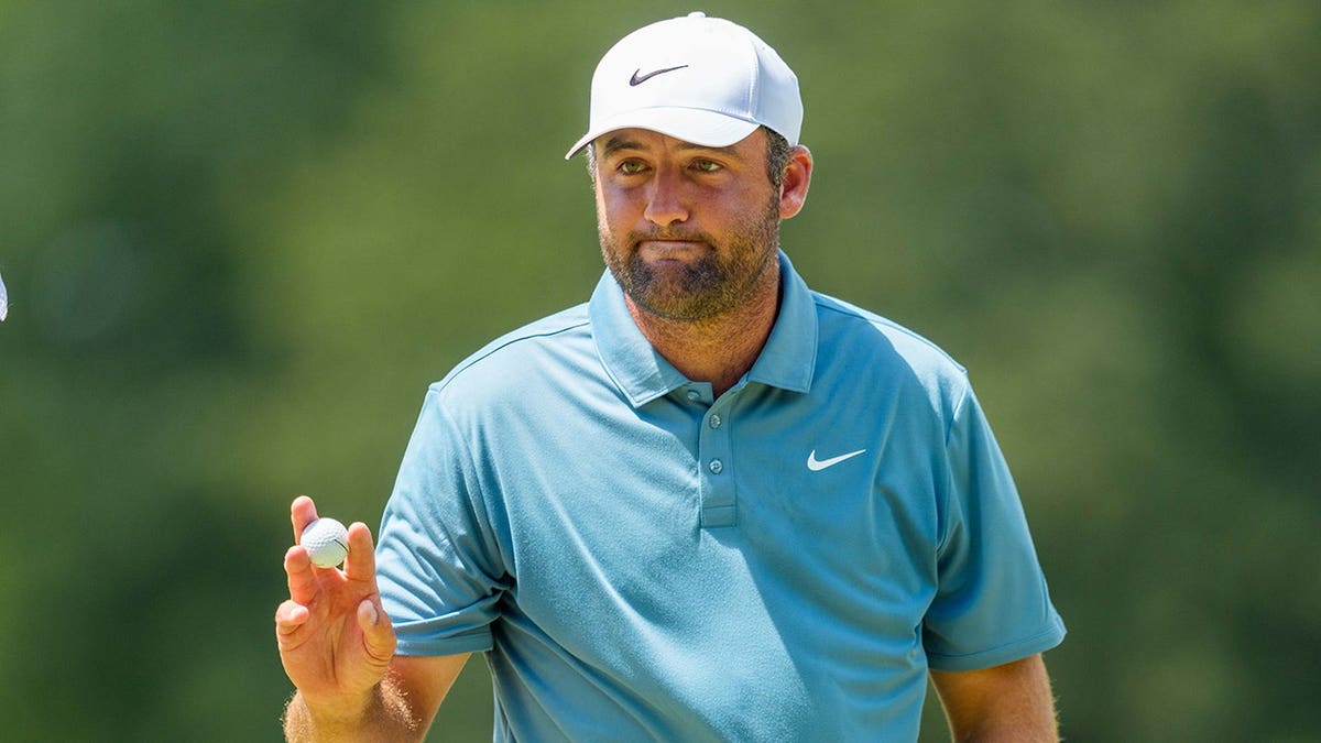 Scottie Scheffler acknowledges fans after his birdie at East Lake Golf Club.