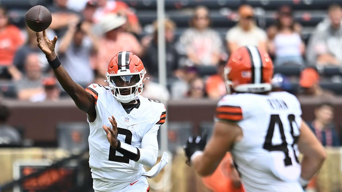 Shedeur Sanders throws a pass to Carsen Ryan during an NFL game.