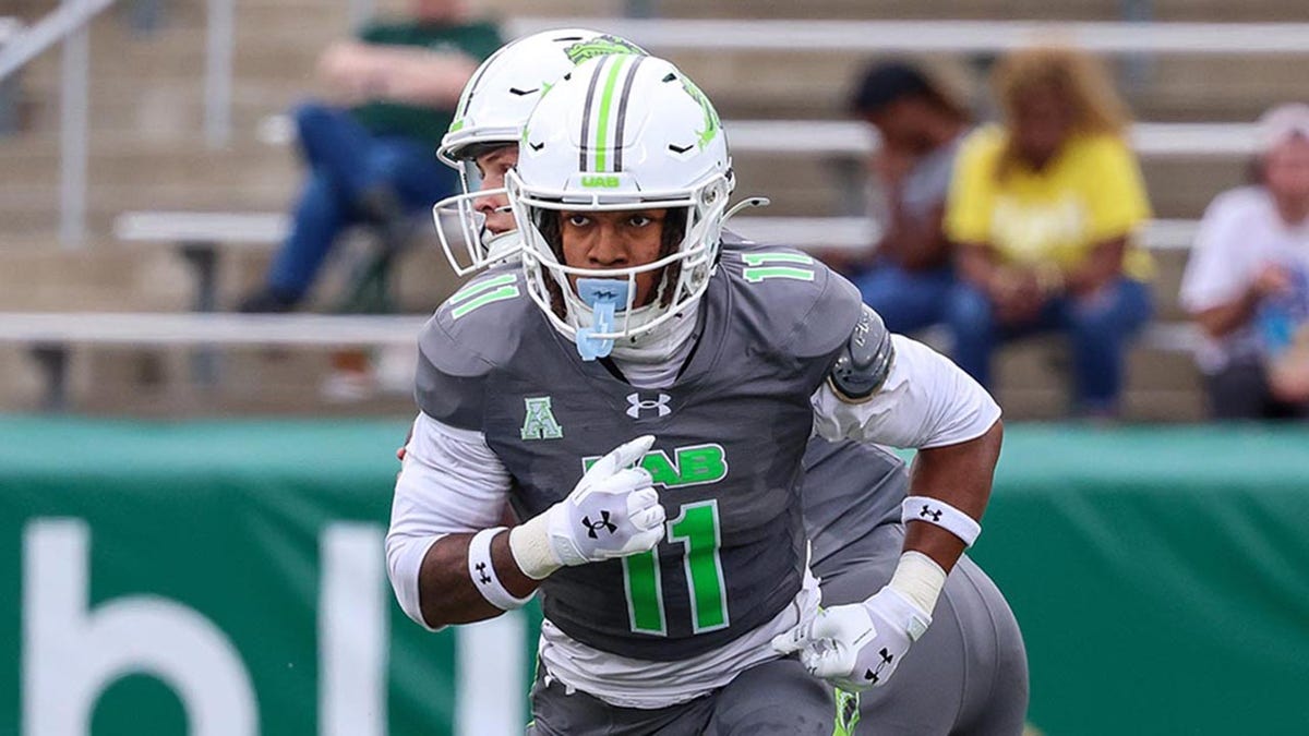 Solomon Beebe runs a play during a college football game