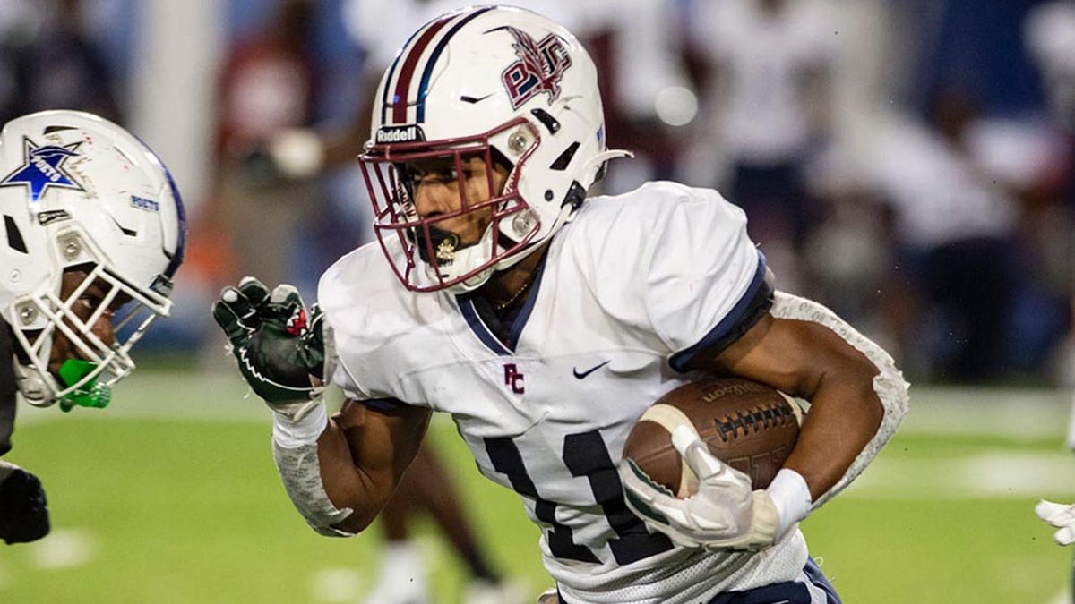 Solomon Beebe carries the ball during a high school football game