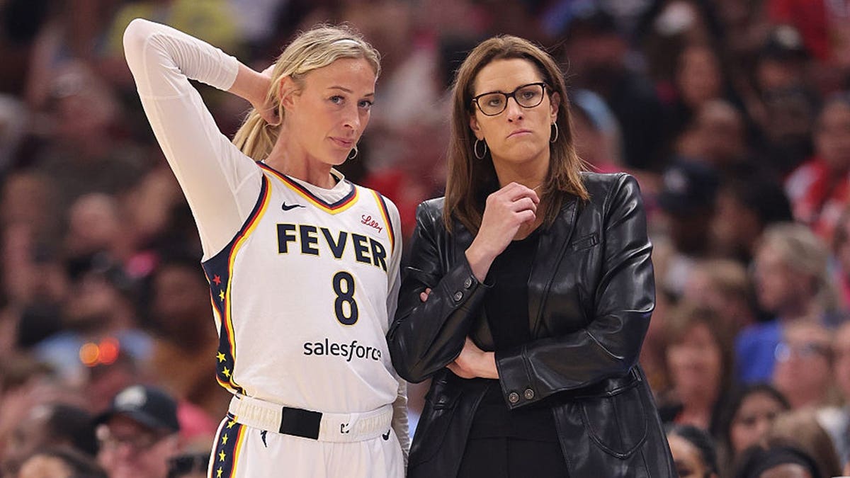 Sophie Cunningham talks with head coach Stephanie White during an Indiana Fever game against the Chicago Sky.