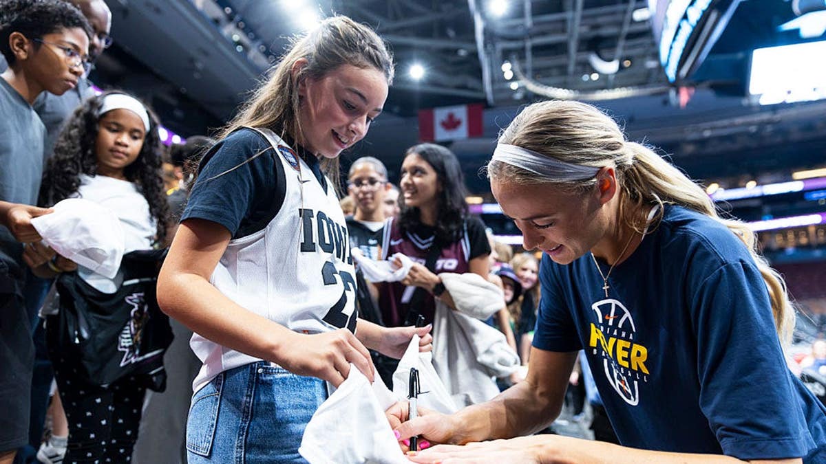 Sophie Cunningham signs autographs before a WNBA game in Toronto.