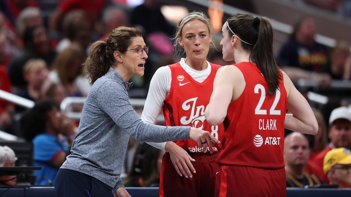 Stephanie White gives instructions to Sophie Cunningham and Caitlin Clark during an Indiana Fever game.
