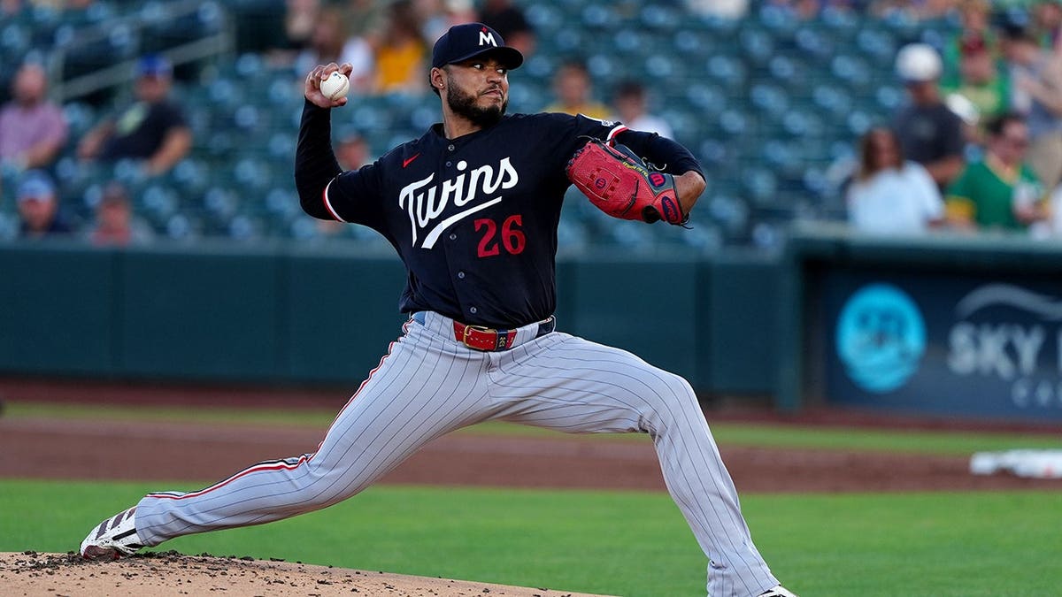 Taj Bradley throws a pitch in the first inning of a baseball game.