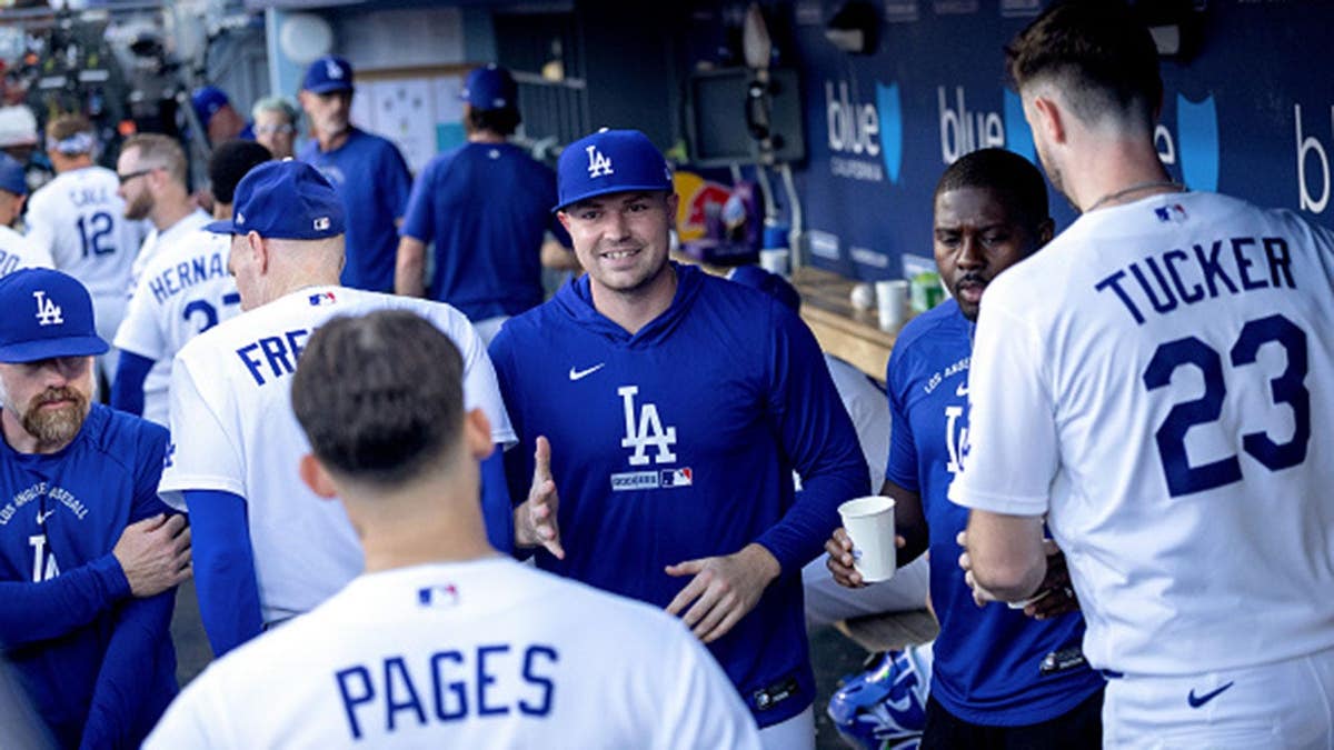 Tarik Skubal greets Andy Pages during an MLB game at Dodger Stadium.