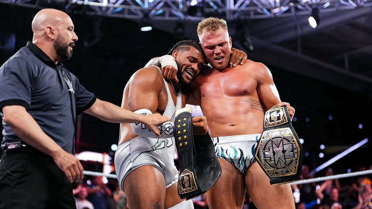 Tavion Heights and Myles Borne embrace at the WWE Performance Center.