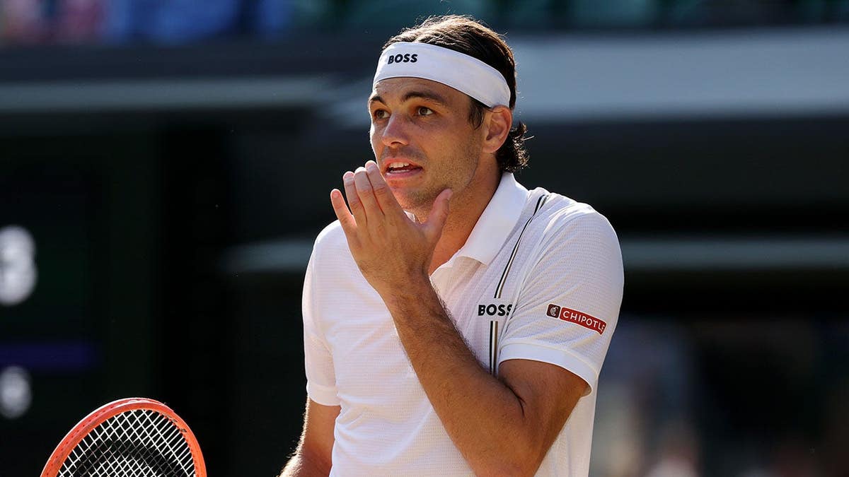 Taylor Fritz reacts during a Gentlemen's Singles quarterfinal match against Alexander Zverev at Wimbledon.