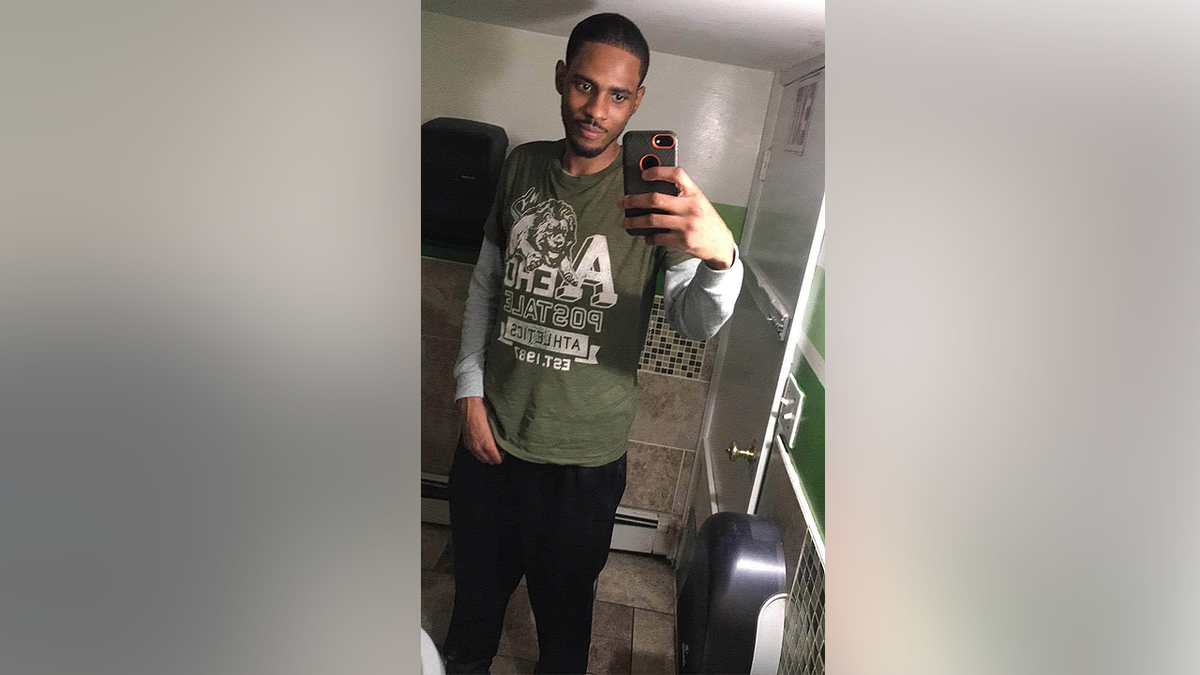 Tayvon Shuler, known as Plucky, poses for a mirror selfie in a family-provided photo