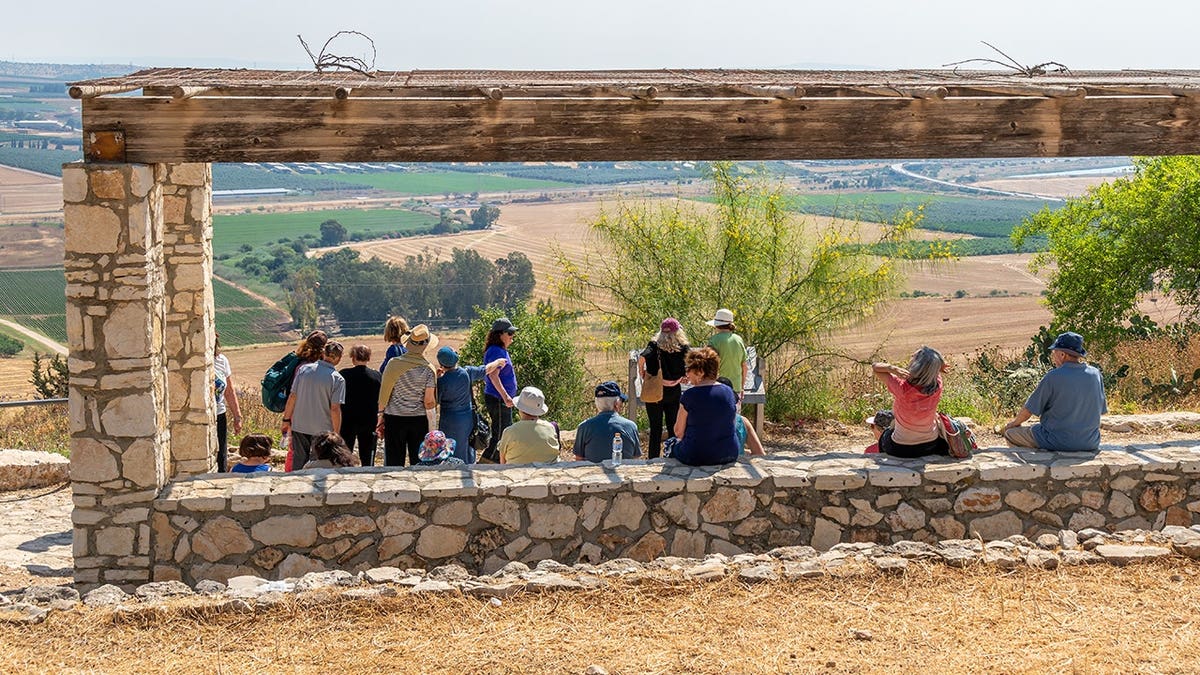 Tourists viewing the Jezreel Valley from Tel Yizre'el in Israel.