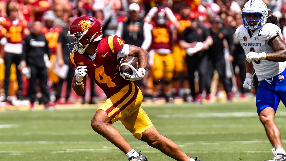 Trent Mosley catches a pass during an NCAA football game at the Coliseum in Los Angeles.