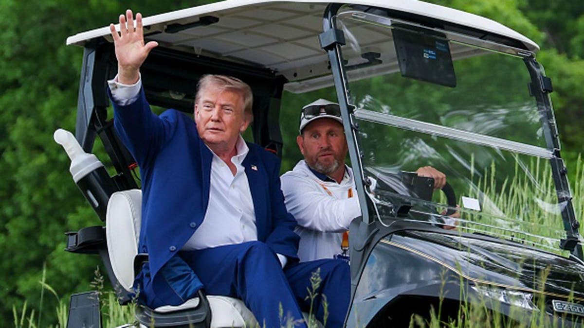 Donald Trump departs via golf cart at Trump National Golf Club during LIV Golf Virginia.