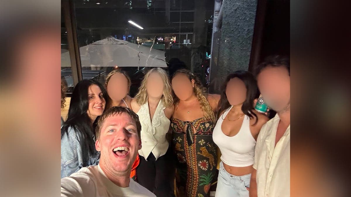 photo shows seven people posing for a photo.