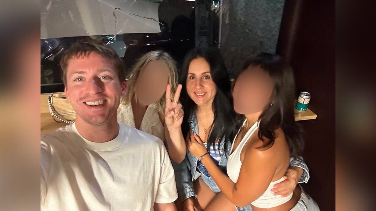 photo shows victim posing for a photo with three other women.