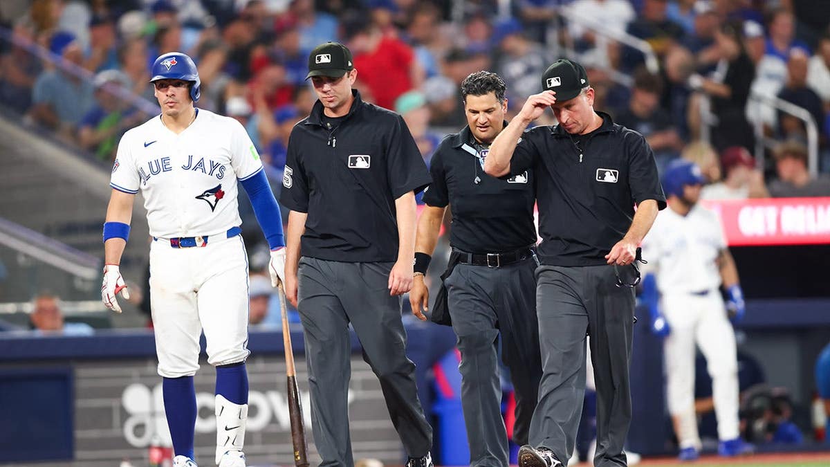 Umpires gather to review a play during an MLB game at Rogers Centre.