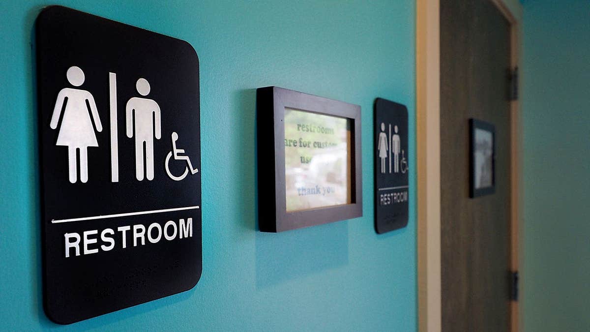 Unisex signs hang outside bathrooms at Toast Paninoteca in Durham, North Carolina.