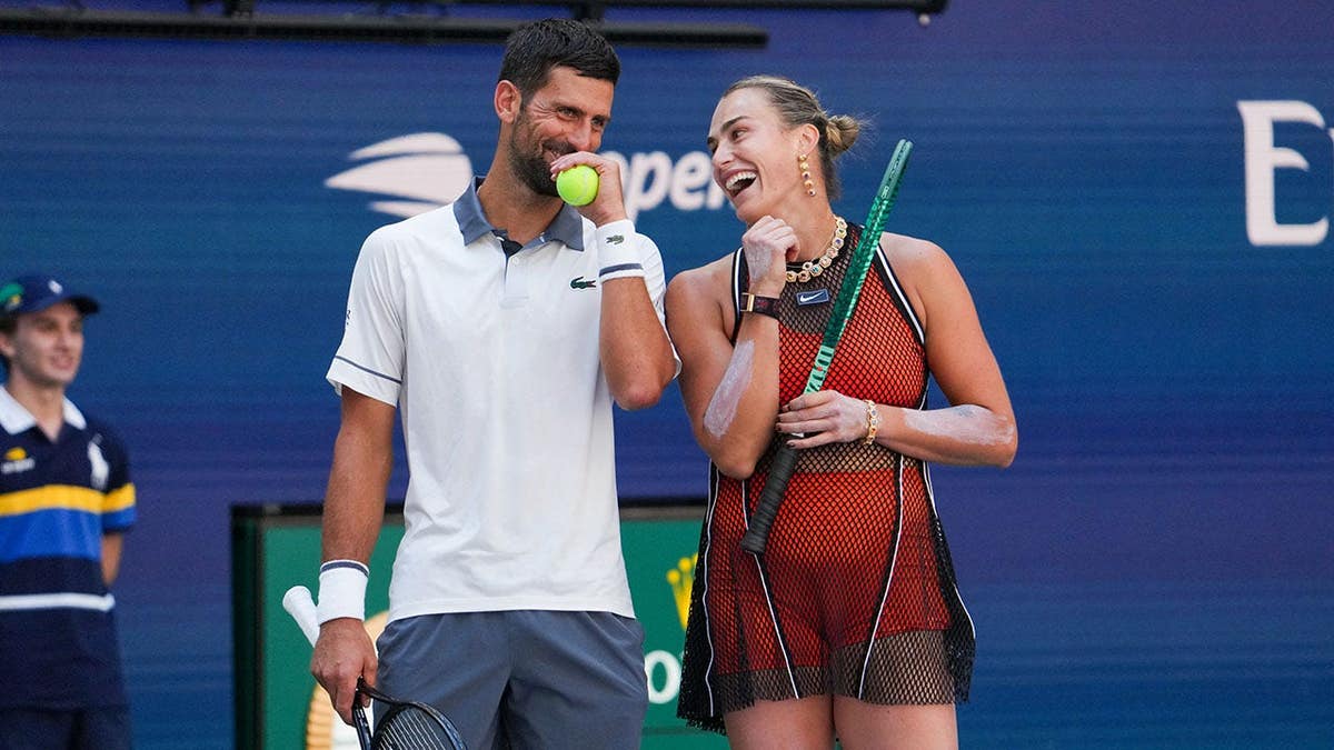 Novak Djokovic and Aryna Sabalenka speak during a mixed doubles tennis match.